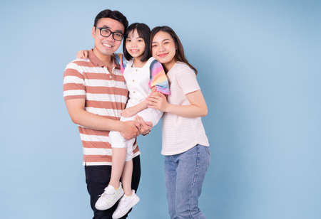 Portrait of young Asian family on backgroundの写真素材