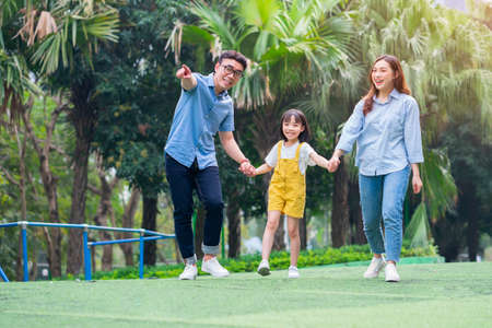 Image of young Asian family playing together at parkの写真素材