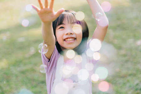 Image of Asian little girl studying at parkの写真素材