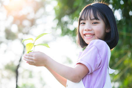 Image of Asian little girl lying on the grass at parkの写真素材