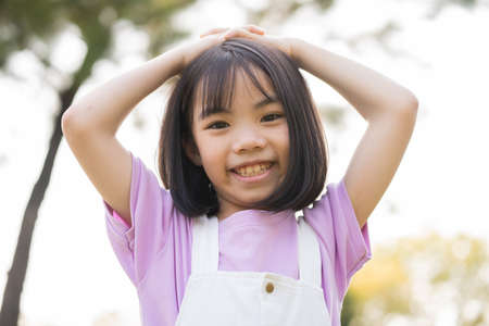 Image of Asian little girl puts used plastic bottles in the trashの写真素材