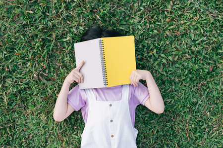 Image of Asian little girl puts used plastic bottles in the trashの写真素材