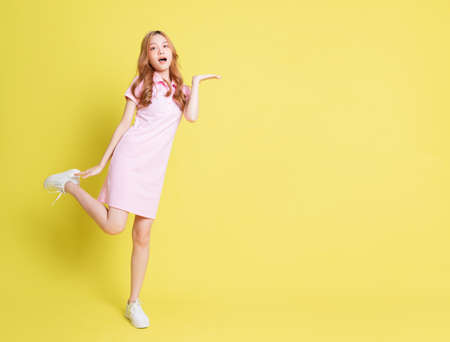 Image of young Asian girl holding swimming float on blue background, summer vacation conceptの写真素材