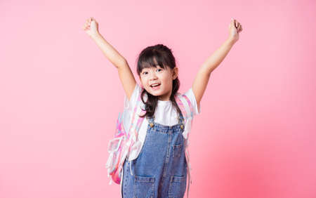 Image of Asian child eating cup cake on background