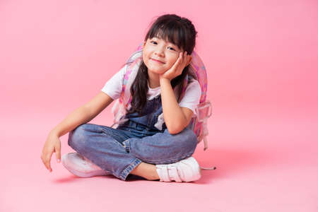 Image of Asian child with suitcase, summer conceptの写真素材