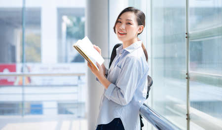Image of young Asian businesswoman working at coffee shop