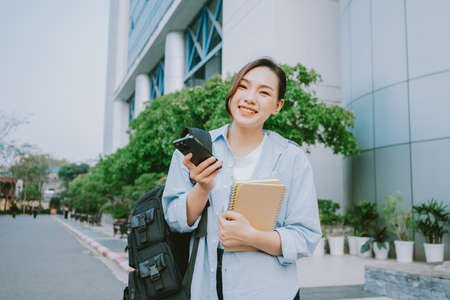 Image of young Asian businesswoman working at coffee shop