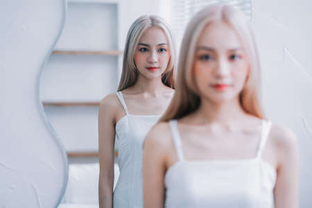 Young Asian girl using smartphone at homeの写真素材