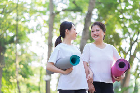 Image of Asian mother and daughter exercise at parkの写真素材