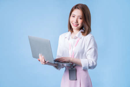 Image of young Asian businesswoman on blue background