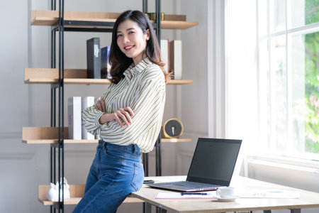 Image of young Asian business woman working at office