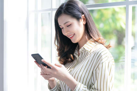 Image of young Asian business woman working at officeの写真素材