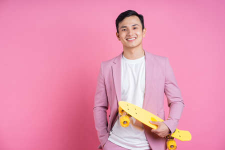 Full length image of young Asian man on white background