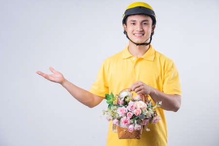 Portrait of young Asian man wearing pink suit posing on backgroundの写真素材