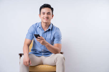 Image of young Asian delivery man on backgroundの写真素材