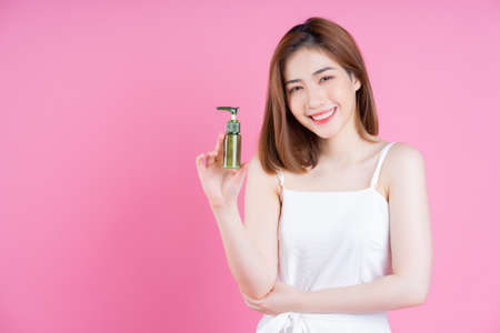 Full length photo of young Asian woman on blue backgroundの写真素材