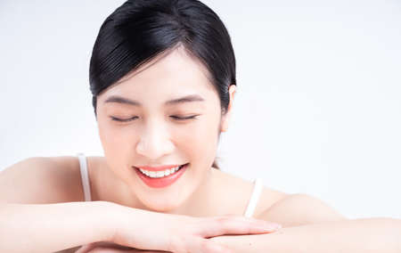 Portrait of young Asian businesswoman on backgroundの写真素材