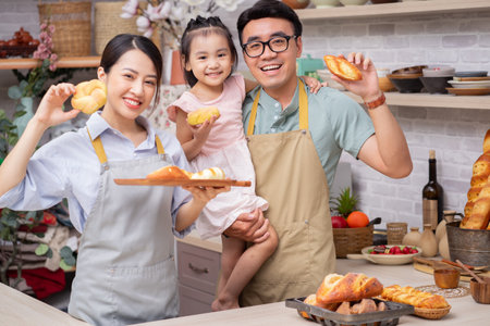 Young Asian family sitting on sofa