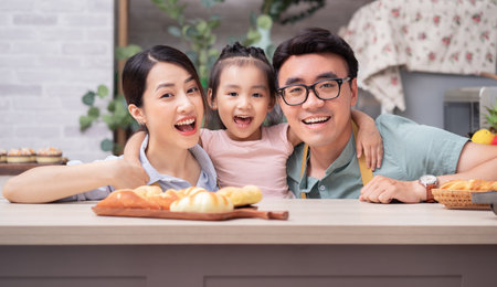 Young Asian family sitting on the floorの写真素材