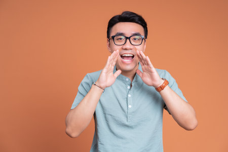 Photo of young Asian man on backgroundの写真素材