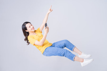 Young Asian businesswoman using laptop on backgroundの写真素材