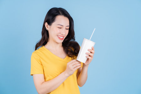 Portrait of young Asian woman on backgroundの写真素材