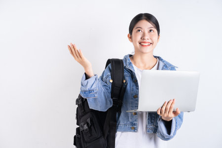 Full length image of young Asian business woman using smartphoneの写真素材