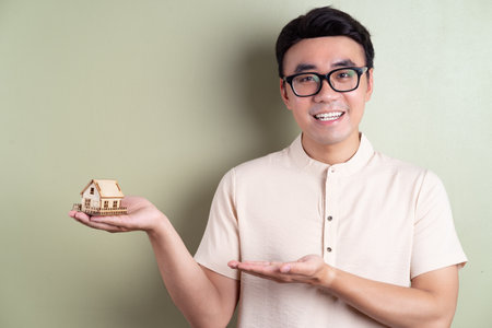 Photo of young Asian man on backgroundの写真素材