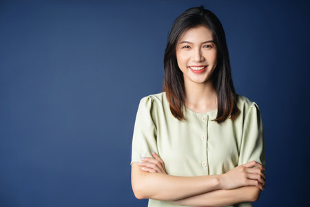 Portrait of young Asian woman on backgroundの写真素材