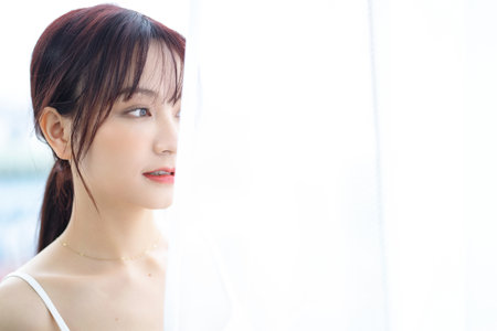 Beauty image of young Asian woman at home in the morningの写真素材