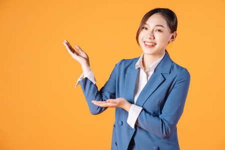 Portrait of young Asian business woman on backgroundの写真素材