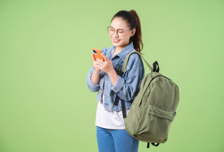 Photo of young Asian college girl on green background