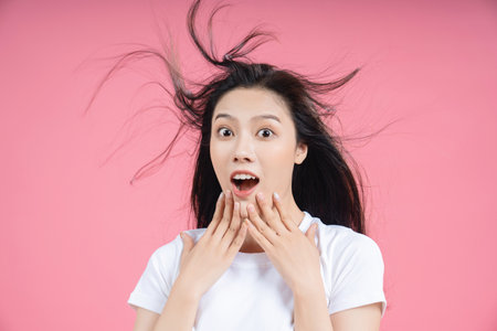 Young Asian woman on backgroundの写真素材
