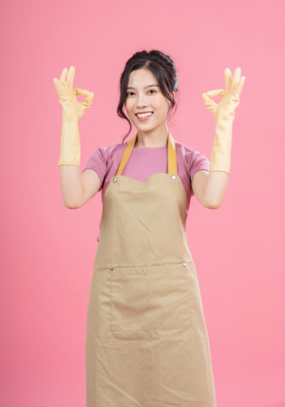 Young Asian woman housewife on backgroundの写真素材