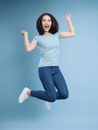 Image of young Asian woman posing on backgroundの写真素材