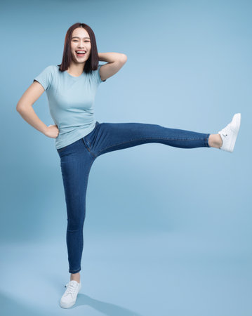 Image of young Asian woman posing on backgroundの写真素材