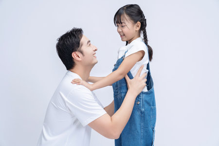 Image of Asian father and daughter on backgroundの写真素材