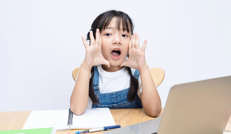 Photo of Asian kid studying on backgroundの写真素材