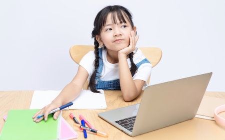 Photo of Asian kid studying on backgroundの写真素材