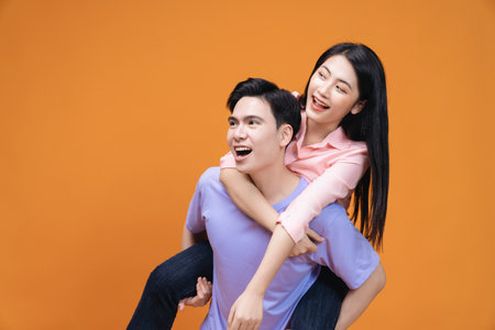 Young Asian couple on backgroundの写真素材