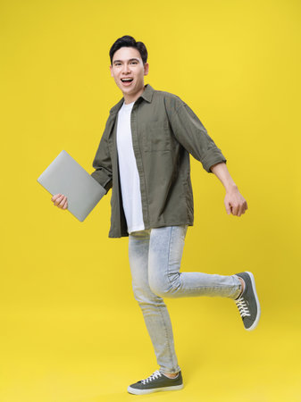 Full length image of young Asian business man standing on backgroundの写真素材