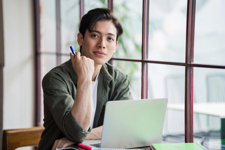 Young Asian businessman working at coffee shopの写真素材