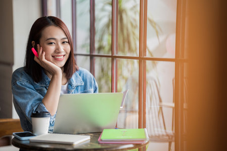 Young Asian businesswoman working at coffee shopの写真素材