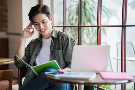 Young Asian businessman working at coffee shopの写真素材