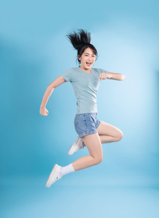 Asian woman on blue backgroundの写真素材