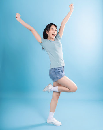 Asian woman on blue backgroundの写真素材