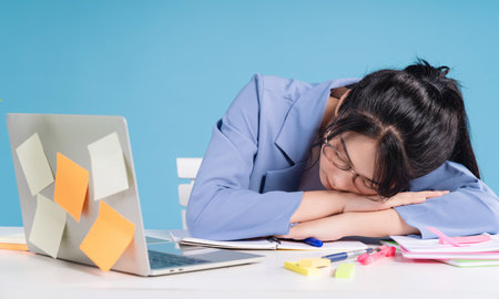 Young Asian businesswoman working on backgroundの写真素材