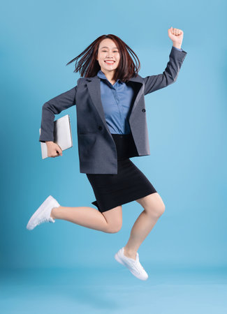 Asian businesswoman on blue backgroundの写真素材
