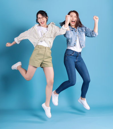 Two women on blue backgroundの写真素材