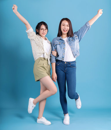 Two women on blue backgroundの写真素材